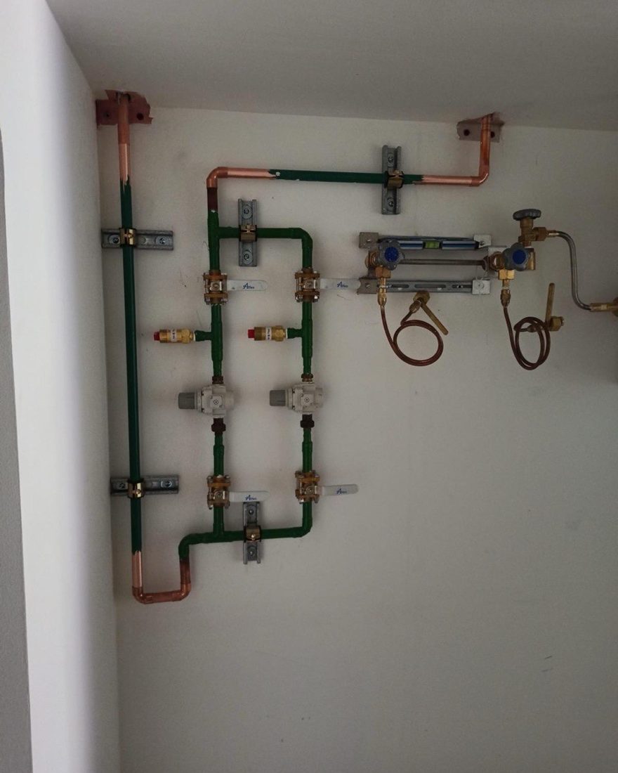 Copper medical gas pipelines with pressure regulators on a wall